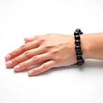 The large bracelet is demonstrated by the model