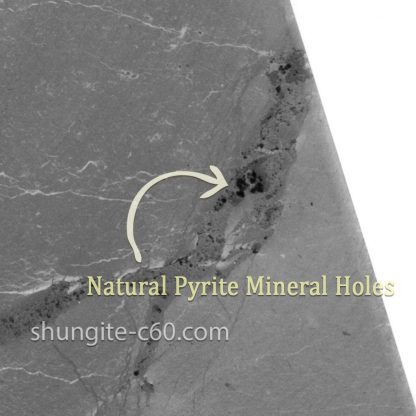 surface shungite and natural pyrite holes on stone