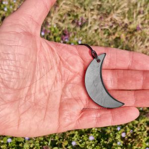 pendant in the form of a crescent in the hand