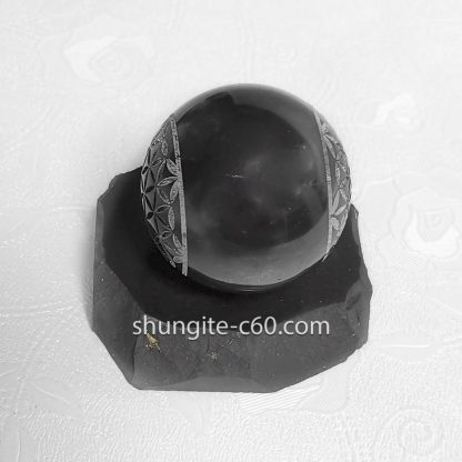 black sphere with engraved flower of life on both sides
