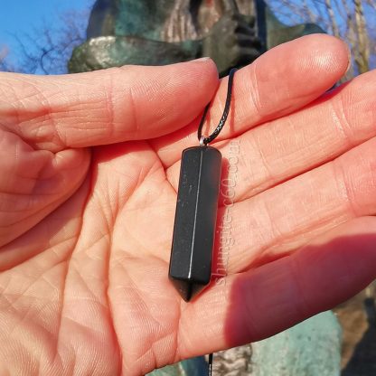 shungite crystals pendant in the hand
